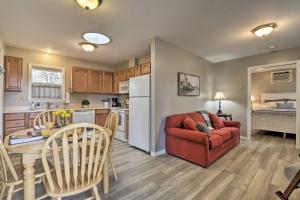 a living room and kitchen with a couch and a table at Centrally Located South Hill Apartment with Smart TV in Spokane