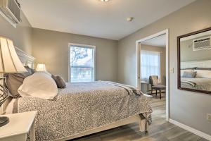 a bedroom with a bed and a mirror at Centrally Located South Hill Apartment with Smart TV in Spokane