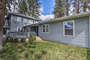 a gray house with a porch and a yard at Centrally Located South Hill Apartment with Smart TV in Spokane