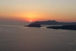 a sunset over a large body of water at Spectacular view Caldera St Μ in Megalochori