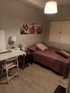 a bedroom with two beds and a desk and a table at Tenerife in Santa Cruz de Tenerife