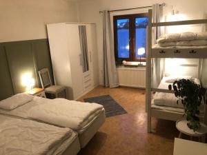 a bedroom with two bunk beds and a window at Elisabets Vandrarhem Hemse in Hemse
