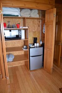 a small kitchen in a tiny house with a refrigerator at Serenity On The Lake in Auburn