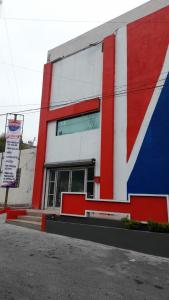 a red white and blue building with a sign at Special HOEStel in Monterrey! in Monterrey