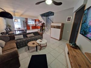 a living room with a couch and a table at Jani's Beach House in Neoi Epivates