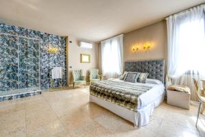a bedroom with a bed and a large window at Prestige Suite Sirmione in Sirmione