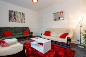 a living room with two couches and a table at Staywhenever HS- 4 Bedroom House, King Size Beds, Sleeps 9 in Stoke on Trent