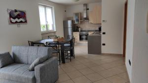 a living room with a couch and a table in a kitchen at Casa Torboli 2 in Arco +4 photos