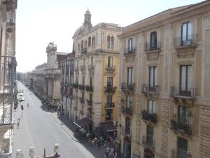 an empty street in a city with buildings at Gianluca's Room in Catania