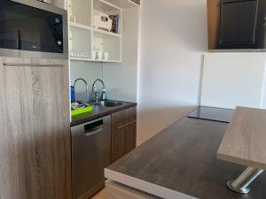 a small kitchen with a sink and a refrigerator at 1600 Ocean Walk in Amadores