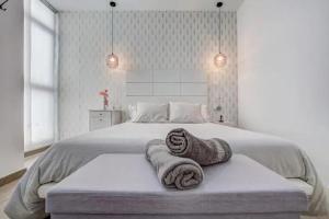 a bedroom with a bed with two towels on it at Casa el Majorero in Puerto del Rosario