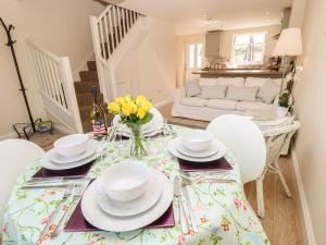 a dining room with a table and chairs at 4 The Old Post Office Mews in Brading