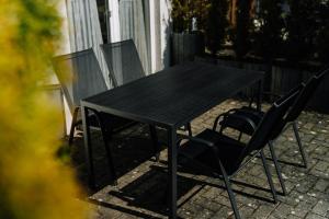 a black table and chairs on a patio at Pension Kristall in Elbingerode