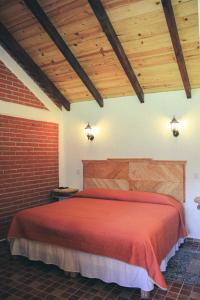 מיטה או מיטות בחדר ב-Cabañas Rincón Escondido