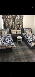 a living room with two beds and a couch at Lamlash (holiday) Lets in Lamlash
