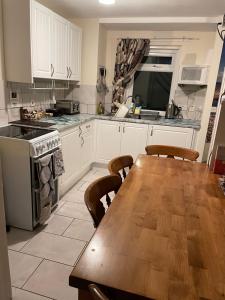 a kitchen with a wooden table and a wooden floor at Lamlash (holiday) Lets in Lamlash