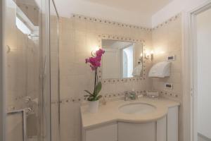 a bathroom with a sink and a mirror and a shower at Capri center holidays in Capri +15 photos