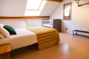 a bedroom with a bed in a room with a window at Auberge de Motz in Motz