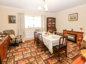 a dining room with a table and a fireplace at The Old Grocery in Hollingwood