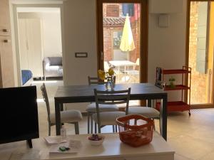 een woonkamer met een eettafel en stoelen bij Appartamento Tre Archi con corte privata in Venetië