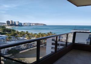 a balcony with a view of the beach and the ocean at APARTAMENTO EDIFICIO LOS LAURELES in Santa Marta