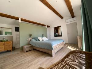 a bedroom with a bed and a wooden floor at La Bastide Blanche Magnifique villa 5 étoiles 5 chambres et piscine privée sur 6500 m VAR in Lorgues +72 photos