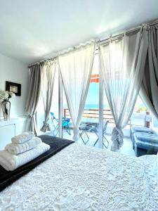 a bedroom with a bed with a view of the ocean at Sweet home deluxe in Playa de las Americas