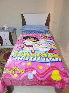 a bedroom with a bed with a pink blanket at سكن للذكور فقط - Sakan Male Only in 6th Of October