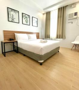 A bed or beds in a room at Bambu Suites