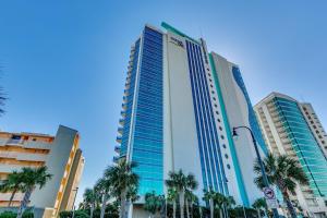 a tall building with palm trees in front of it at Fabulous Ocean Front Penthouse Condo, OO Resort, 21st Fl in Myrtle Beach