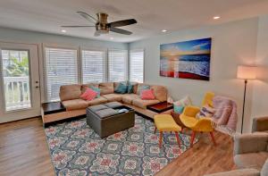 a living room with a couch and chairs and a fan at Gulfpoint 3209 in South Padre Island