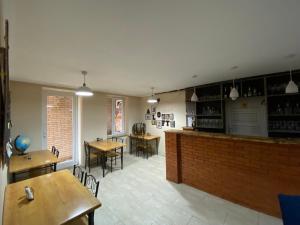 a restaurant with tables and chairs and a bar at Aloft House in Kutaisi