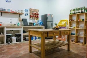 a kitchen with a table in the middle of a room at Meraki Boutique Hostel in San Gil
