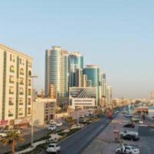 a city with tall buildings and a street with cars at Lemas 901 in Ajman 