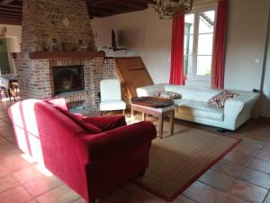 Una sala de estar con un sofá y una chimenea. en Gîte charmant avec jardin, cheminée, Wi-Fi, idéal pour randonnées et découvertes locales - FR-1-376-70, en Torcy