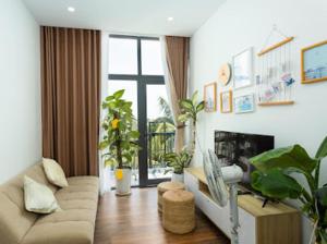 a living room with a couch and a fireplace at Alina Retreat in Hiếu Nhơn