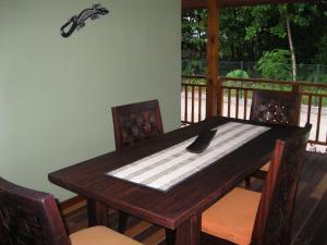 a wooden table with a spoon on top of a deck at Casa Verde in Grand'Anse Praslin