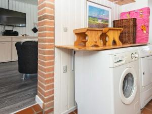 a laundry room with a washer and dryer at 6 person holiday home in Hemmet in Falen