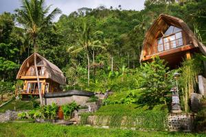 a wooden house in the middle of a forest at Like living in a romantic Balinese painting in Sidemen
