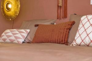 a bed with several pillows on top of it at Apartment Turtle at Windsock Beach in Kralendijk