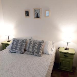a bedroom with two lamps on tables and a bed at Casa Sarmiento in San Francisco del Monte de Oro