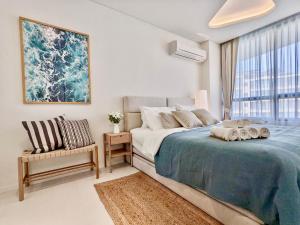 a bedroom with a bed and a chair and a window at Seaview 2 BR Beach front Vacation HuaHin in Hua Hin
