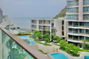 a view of the pool from the balcony of a building at Seaview 2 BR Beach front Vacation HuaHin in Hua Hin