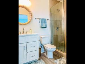 a bathroom with a toilet and a shower and a sink at 1030 Ocean home in Holden Beach
