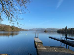 a view of a lake with a dock at Melbourne Guest House in Bowness-on-Windermere