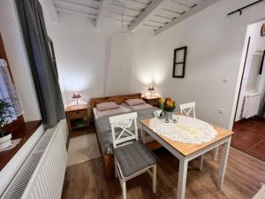 a small room with a table and a bed at Cseri Porta in Szalafő +35 photos