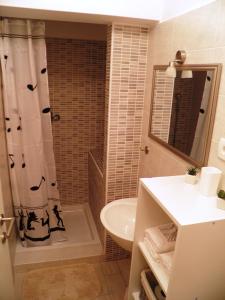 a bathroom with a toilet and a sink and a shower at Studio Apartment MD in Roč