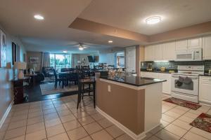 a kitchen and living room with a table and chairs at Yacht Club Villas #2-204 condo in Myrtle Beach