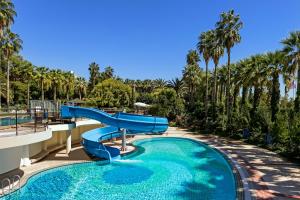 a slide in a swimming pool at a resort at Özkaymak Falez Hotel in Antalya