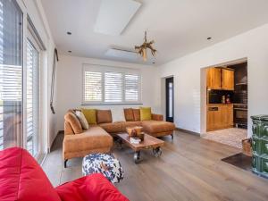 a living room with a couch and a table at Snug holiday home in Wei briach with terrace in Weissbriach